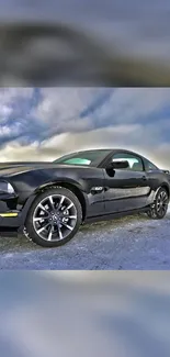 Black sports car on icy ground with a cloudy sky backdrop.