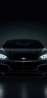 Sleek black sports car with glowing headlights on a dark background.