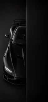 Sleek black sports car on dark background.