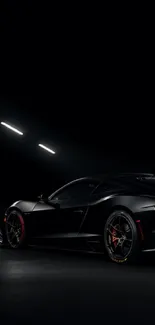 Sleek black sports car in a dimly lit tunnel, showcasing luxury and speed.