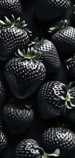 Close-up of glossy black strawberries on a wallpaper background.