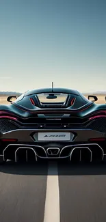 Sleek black supercar on open road, rear view.