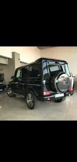 Luxurious black SUV displayed in a modern showroom.