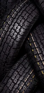 Close-up of wet black tire treads forming a sleek pattern.