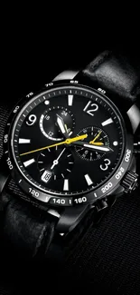 Sleek black watch with a chronograph design on dark background.