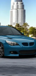 Sleek blue car in an urban cityscape background.