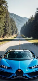 A blue sports car on a scenic highway lined with trees.