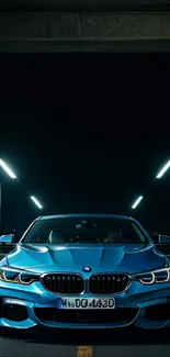 Blue sports car under city lights at night, showcasing elegance.