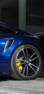 Sleek blue sports car rear view in showroom.