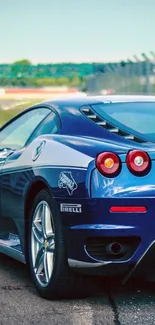 Blue sports car on a race track, perfect for phone wallpaper.