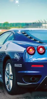 Vibrant blue sports car parked on a race track, capturing speed and luxury.