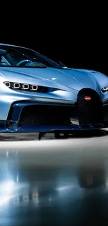 Sleek blue sports car on reflective surface in HD wallpaper.