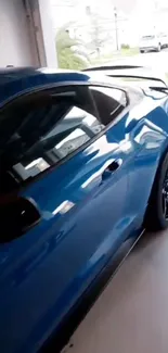 Sleek blue sports car parked in garage.