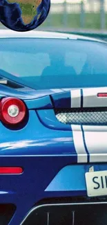 Sleek blue sports car with vibrant stripes and a modern design.