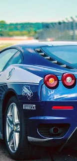 Blue sports car on a race track, sleek design.