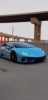 Blue Lamborghini on highway at dusk.