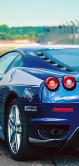 Sleek blue sports car on a racing track.