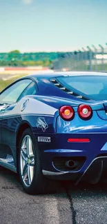Stylish blue sports car on a racetrack with a dynamic design.