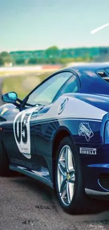 Sleek blue sports car on a racetrack, showcasing speed and luxury.