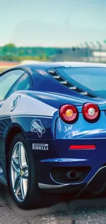 Sleek blue sports car on racetrack, ideal for mobile wallpaper.