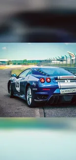 Blue sports car on race track wallpaper.