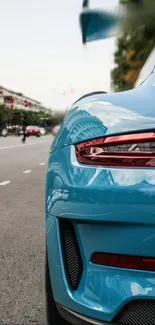 Sleek blue sports car parked on urban street.