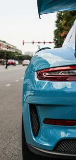 Sleek blue sports car on city street during daytime.