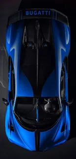 Top view of sleek blue Bugatti car on a dark background.