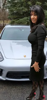 Elegant woman in black dress beside a silver car