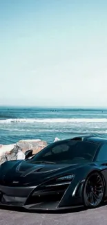 Black sports car near ocean with scenic view.