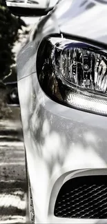 Close-up of luxury car highlighting sleek design and modern headlight.