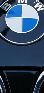 Sleek BMW car emblem on dark blue background.