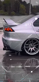 Sleek silver car with a futuristic digital overlay on wet pavement.