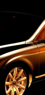 Sleek car with golden glow on black background.