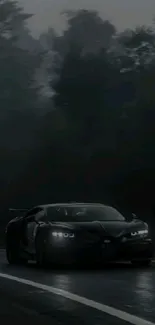 Sleek black car driving in a dark forest setting.