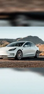 A sleek white car in a desert landscape with mountains in the background.