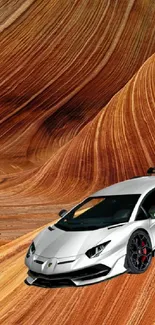 Silver car amidst stunning desert waves in vibrant orange hues.