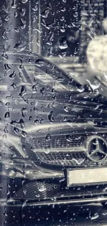 Luxury black car with rain droplets on the windshield in urban setting.