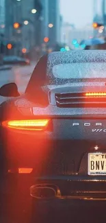 Luxury sports car on a rainy city street with vibrant lights.