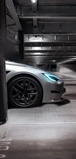 Sleek silver car with blue headlights in a modern parking garage.