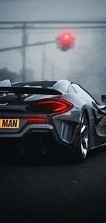Sleek sports car in foggy urban night setting with glowing taillights.