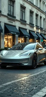 Silver sports car on urban cobblestone street.