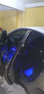 Car interior with blue lights at night in a yellow-walled setting.