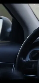 Sleek car interior with steering wheel and mirror reflection.