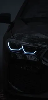 Sleek black car with glowing LED headlights at night