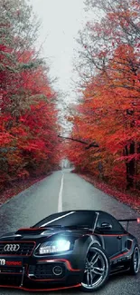 Sleek sports car on scenic autumn road surrounded by red-orange trees.