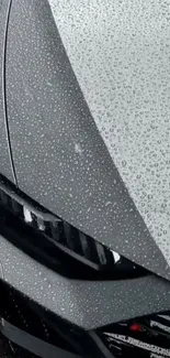 Close-up of a sleek car hood with raindrops, smartphone wallpaper.