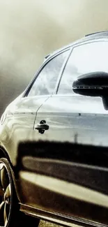 Silhouette of a sleek, metallic finished car on a dark background.