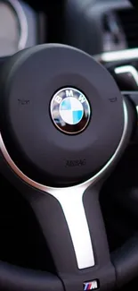 Black steering wheel in luxury car interior.