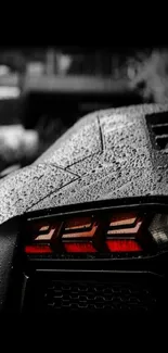 Stylish car tail light in rain on black background, perfect for mobile wallpaper.